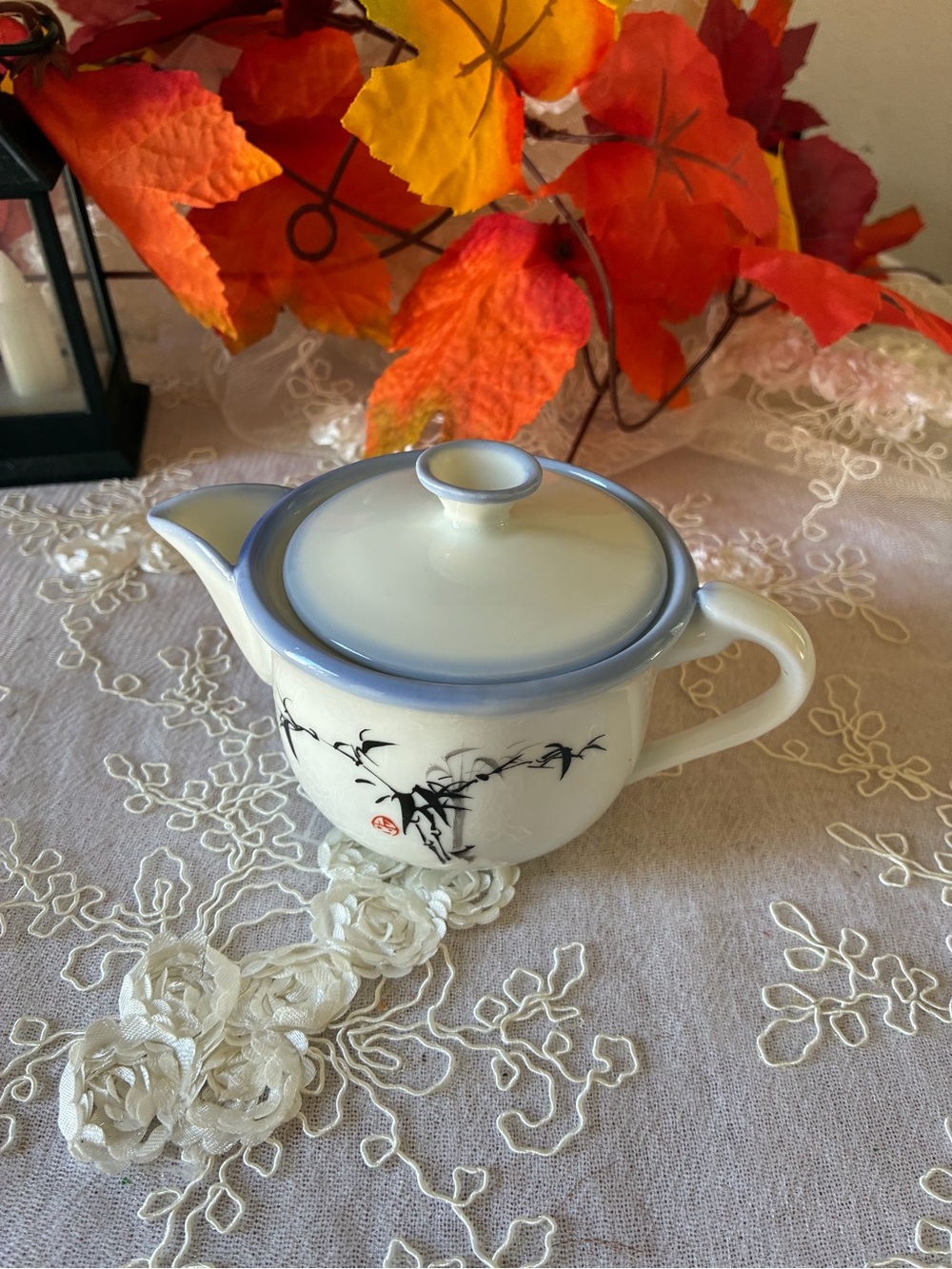 Classic White Ceramic Teapot with Blue Rim and Bamboo Motif